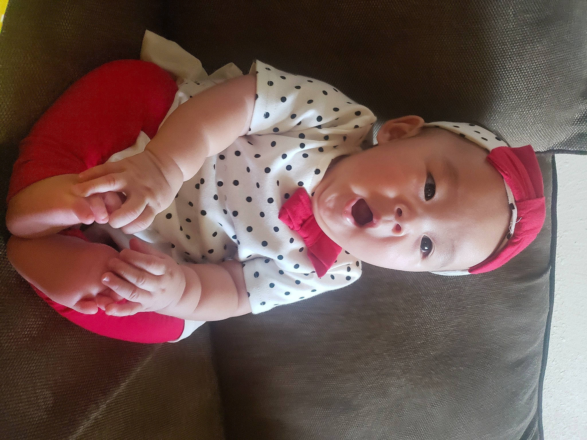 Alanie is registered to the contest to win money with this photo: baby, baby_products, baby_toddler_clothing, cheek, child, couch, nail, person, polka_dot, surprise, toddler