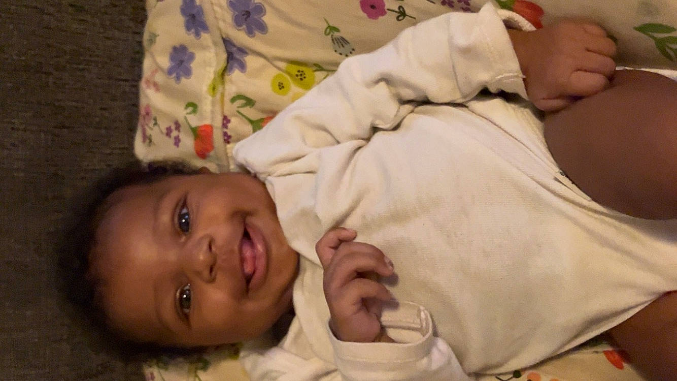 Serenity is registered to the contest to win money with this photo: baby, baby_toddler_clothing, cheek, child, comfort, eye, eyebrow, finger, gesture, hand, happy, head, joy, mouth, nose, person, room, skin, sleeve, smile