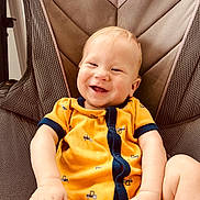 Huxlee joined the competition — help win amazing prizes! baby, babylaughing, bodypart, chair, clothing, cushion, face, finger, furniture, happy, head, homedecor, laughing, pants, person, photography, portrait, sitting, smile, t_shirt