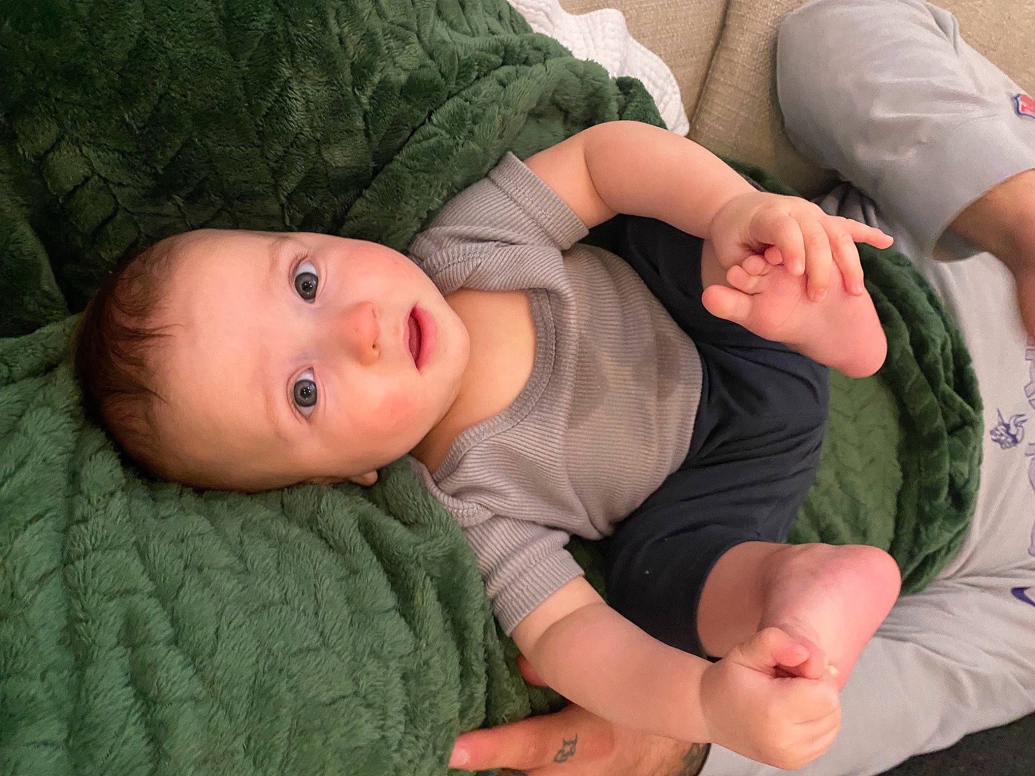 Jetson is registered to the contest to win money with this photo: baby, baby_toddler_clothing, child, comfort, elbow, facial_expression, finger, gesture, grass, hand, head, human_body, joint, lap, leg, person, skin, thigh, toddler, tree
