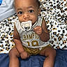 baby, infant, pacifier, clothing, champion, sporty, sitting, blanket, leopard_print, bed, white_shoes, curious, cute, indoors, person, child, footwear, sock, portrait, young