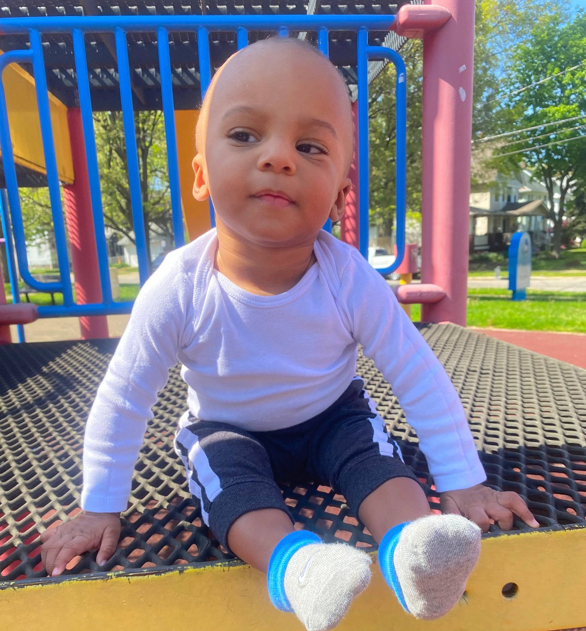 Cartier is registered to the contest to win money with this photo: baby, baby_toddler_clothing, blue, child, city, electric_blue, fun, grass, happy, leisure, outdoor_play_equipment, person, plant, play, playground, recreation, sitting, sleeve, smile, toddler