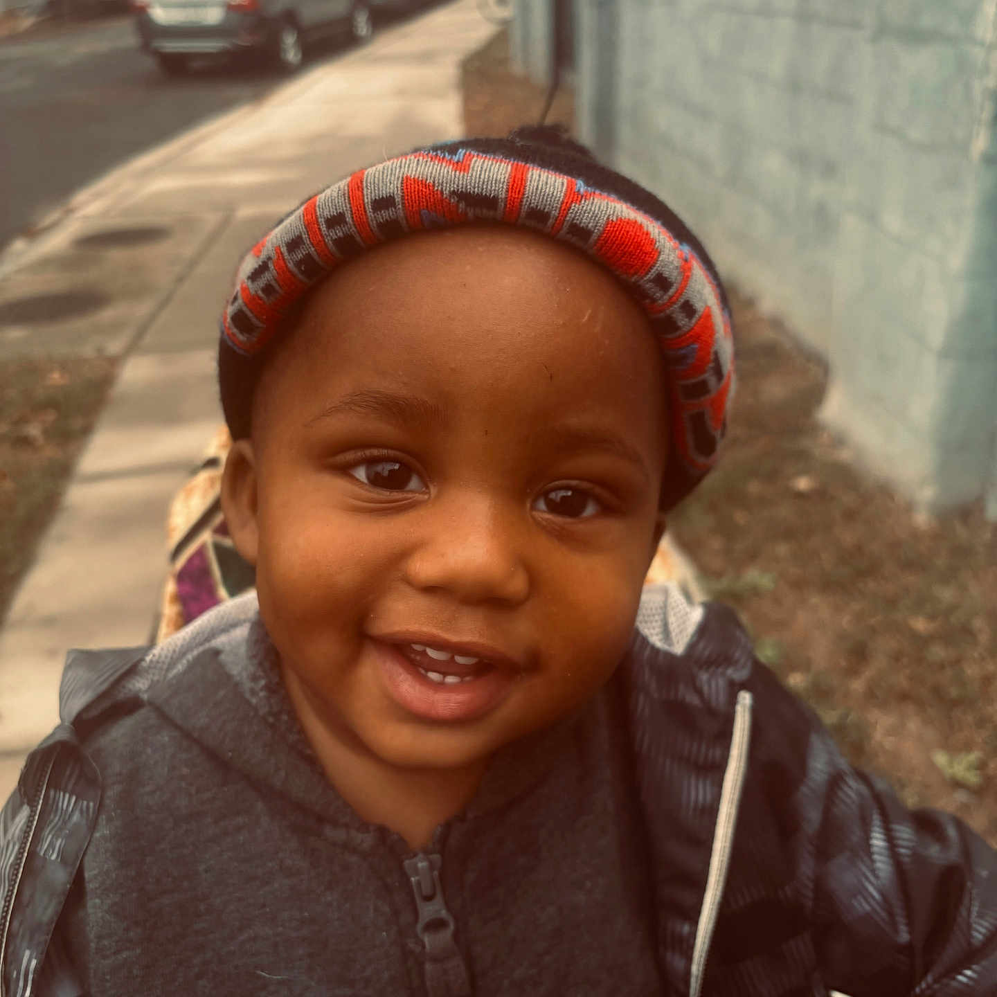 Ezekiel joined the competition — help win amazing prizes! boy, cap, car, child, clothing, coat, face, happy, hat, head, jacket, machine, male, person, photography, portrait, smile, transportation, vehicle, wheel