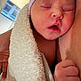 Stori is registered to the contest to win money with this photo: baby, newborn, infant, sleeping, hospital, towel, blanket, hat, swaddle, close_up, portrait, skin, fist, parent_arm, peaceful, mouth_open, eyelids, cheek, indoor, human