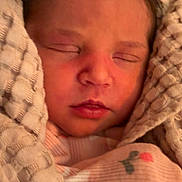 Stori is registered to the contest to win money with this photo: baby, newborn, sleeping, swaddled, blanket, closeup, infant, face, lips, cheeks, hair, portrait, video_call_thumbnail, screen_indicator, mobile_ui, cozy, bedroom, soft_texture, pink_clothing, parent