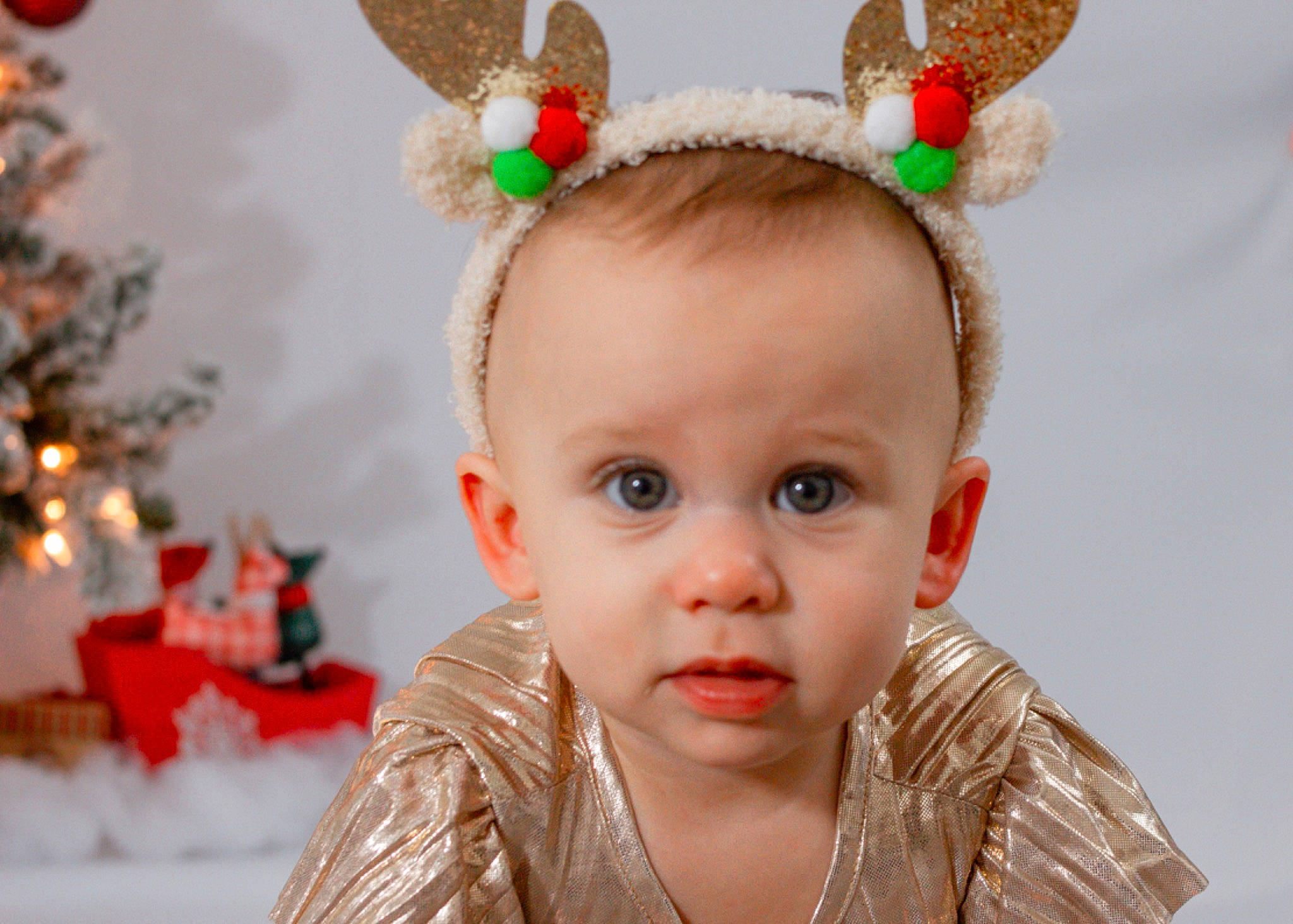 Milani joined the competition — help win amazing prizes! cheek, child, christmas_decoration, christmas_eve, christmas_ornament, christmas_tree, costume_hat, event, eyelash, fun, happy, head, headband, holiday, organ, ornament, person, red, skin, toddler