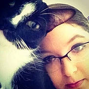 Callie is registered to the contest to win money with this photo: black_fur, cat, close_up, companion, cuddling, cute, eye_contact, eyeliner, face, glasses, indoor, mouth, nose, person, pet, portrait, selfie, tuxedo_cat, whiskers, white_fur