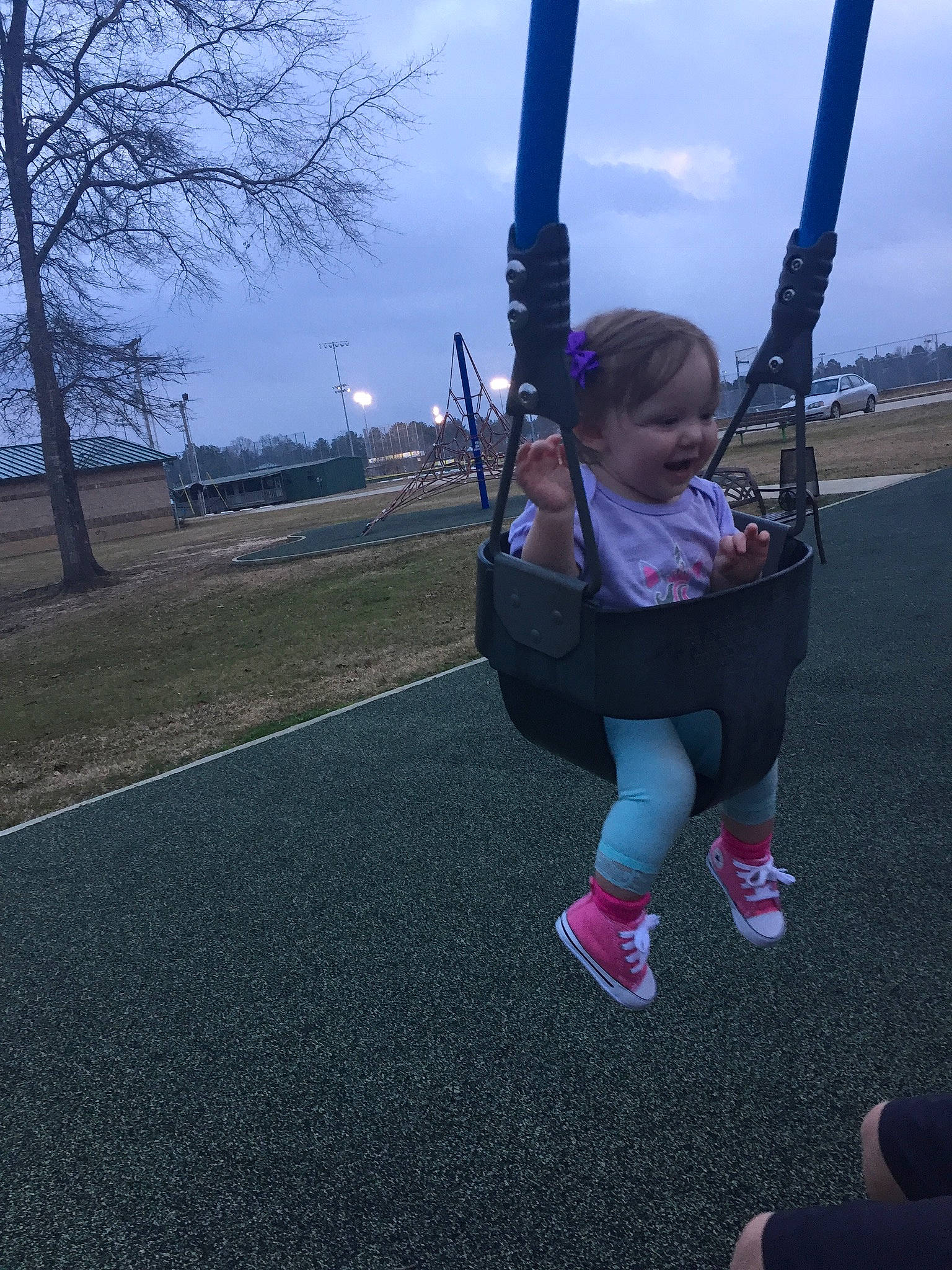 Adalee is registered to the contest to win money with this photo: fun, outdoor_play_equipment, person, playground, public_space, recreation, sky, swing, tree
