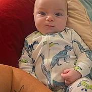 Maverick joined the competition — help win amazing prizes! baby, infant, dinosaur_onesie, cushion, blanket, tattoo, arm, face, clothing, child, indoors, portrait, comfort, cute, person, newborn, lying_down, soft_fabric, resting, expression