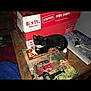 Sylvia is registered to the contest to win money with this photo: animal, black_and_white_cat, book, cat, clutter, copy_paper_box, cozy, domestic, feline, fire_engine_book, indoor, kitten, literature, military_aircraft_book, pet, relaxation, resting, small_cat, table, wooden_table