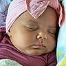 Jaleah is registered to the contest to win money with this photo: baby, infant, sleeping, portrait, close_up, face, pink_bow, headband, blanket, bundled, peaceful, indoors, soft_lighting, maroon_clothing, textile, cozy, lying_down, nursery, cute, photography
