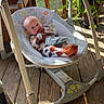 Drew is registered to the contest to win money with this photo: baby, baby_swing, porch, wooden_floor, sunlight, plant, potted_plant, footwear, pajamas, infant, child, outdoor, seat, relaxing, daylight, cute, person, baby_clothes, face, home