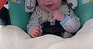 Drew is registered to the contest to win money with this photo: baby, smiling, blanket, car_seat, infant, child, toy, watermelon, seatbelt, happy, face, clothing, indoor, person, head_support, cute, safety, comfort, young_child, portrait