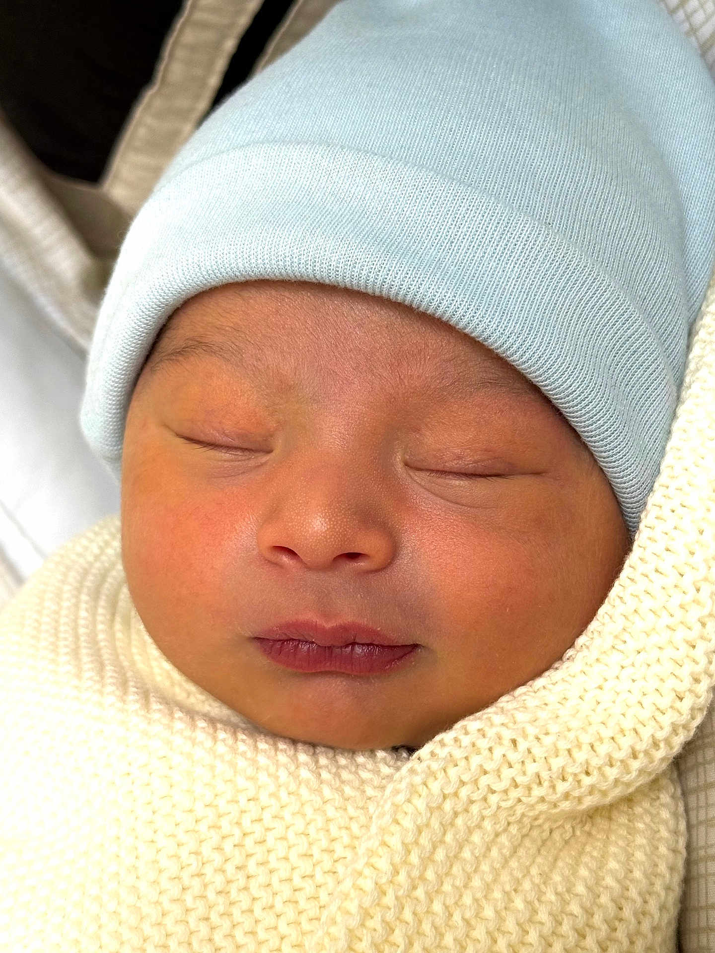 Marlex is registered to the contest to win money with this photo: newborn, baby, sleeping, face, hat, knit_blanket, closeup, infant, wrapped, cozy, soft_texture, peaceful, child, skin, portrait, headwear, resting, cute, fresh, tiny