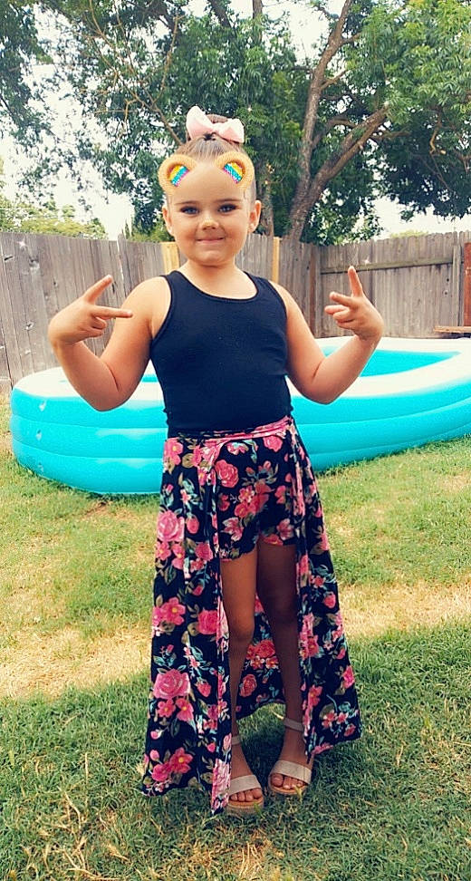 Angilea is registered to the contest to win money with this photo: clothing, fun, grass, happy, headwear, joy, knee, leg, leisure, person, pink, recreation, smile, sportswear, street_fashion, summer, swimwear, t_shirt, thigh, toddler