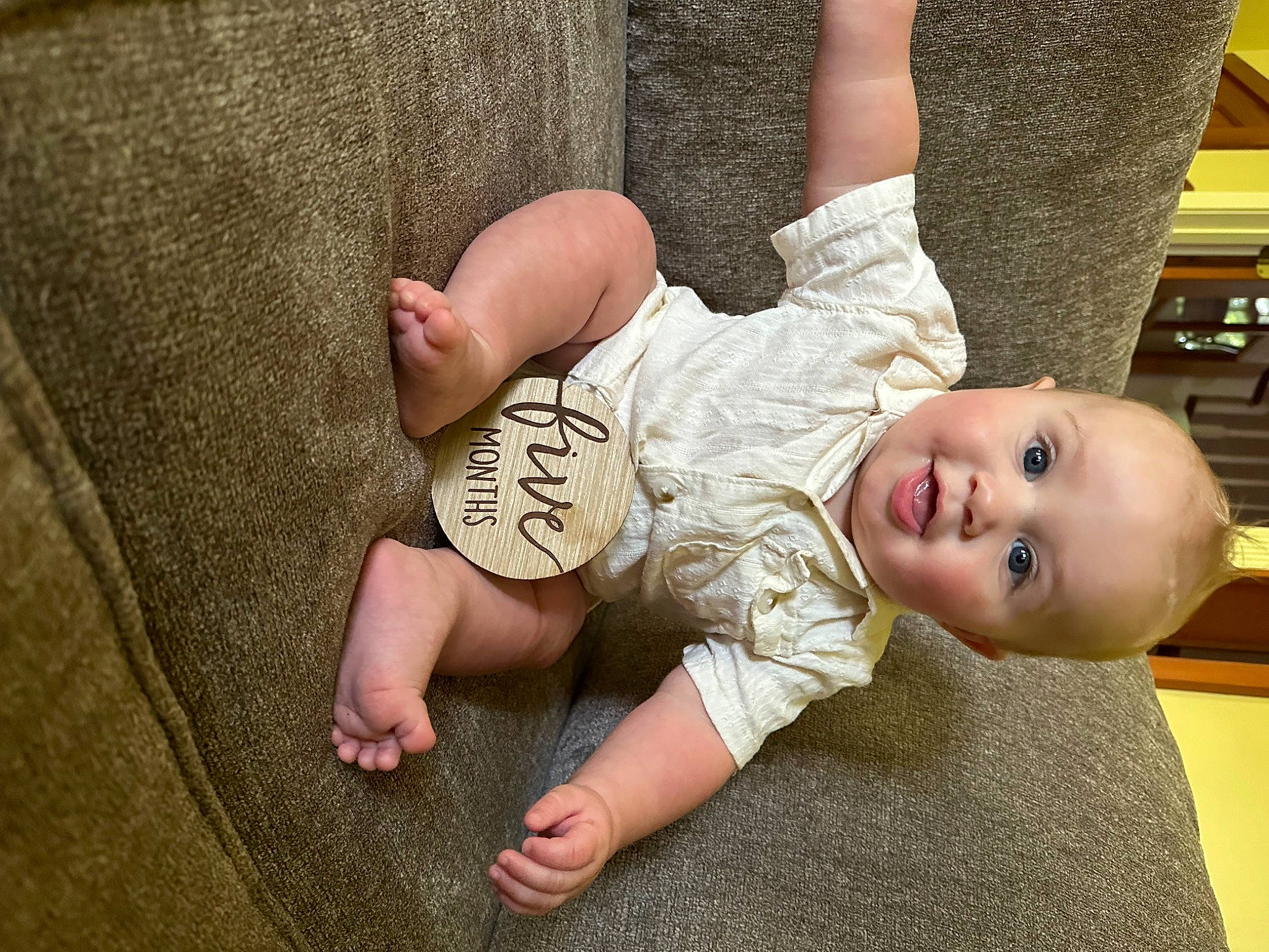 Clyde is registered to the contest to win money with this photo: arm, baby, baby_toddler_clothing, cheek, chin, comfort, finger, flash_photography, flooring, fun, gesture, grass, happy, human_body, leg, person, skin, sleeve, smile, toddler