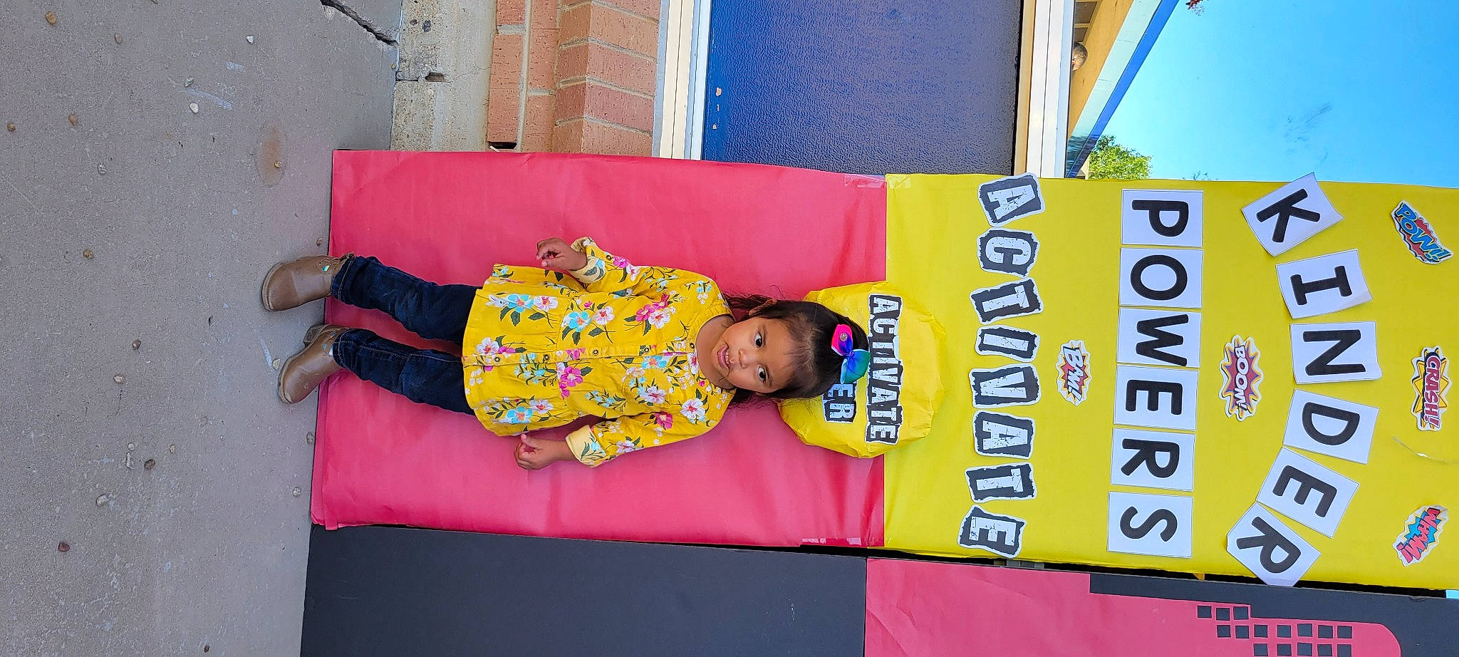 Violet is registered to the contest to win money with this photo: advertising, beauty, child, event, flooring, font, fun, leisure, logo, magenta, orange, pattern, person, pink, room, sandal, t_shirt, toddler, window