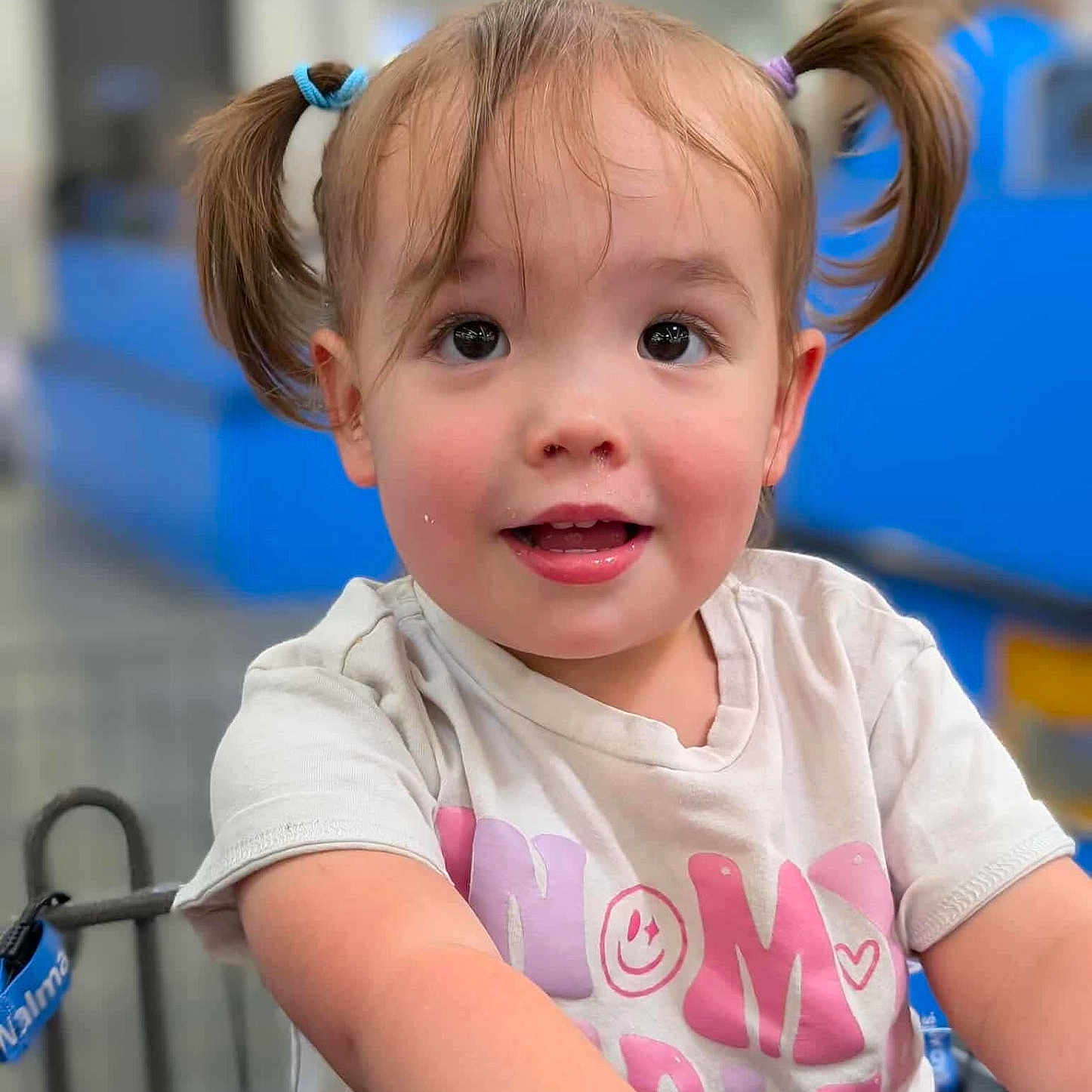 Savannah joined the competition — help win amazing prizes! blonde_hair, casual_clothing, child, close_up, cute, expression, eyes, face, happy, indoor, person, pigtails, playful, portrait, shirt, shopping_cart, short_sleeves, smiling, toddler, young_child