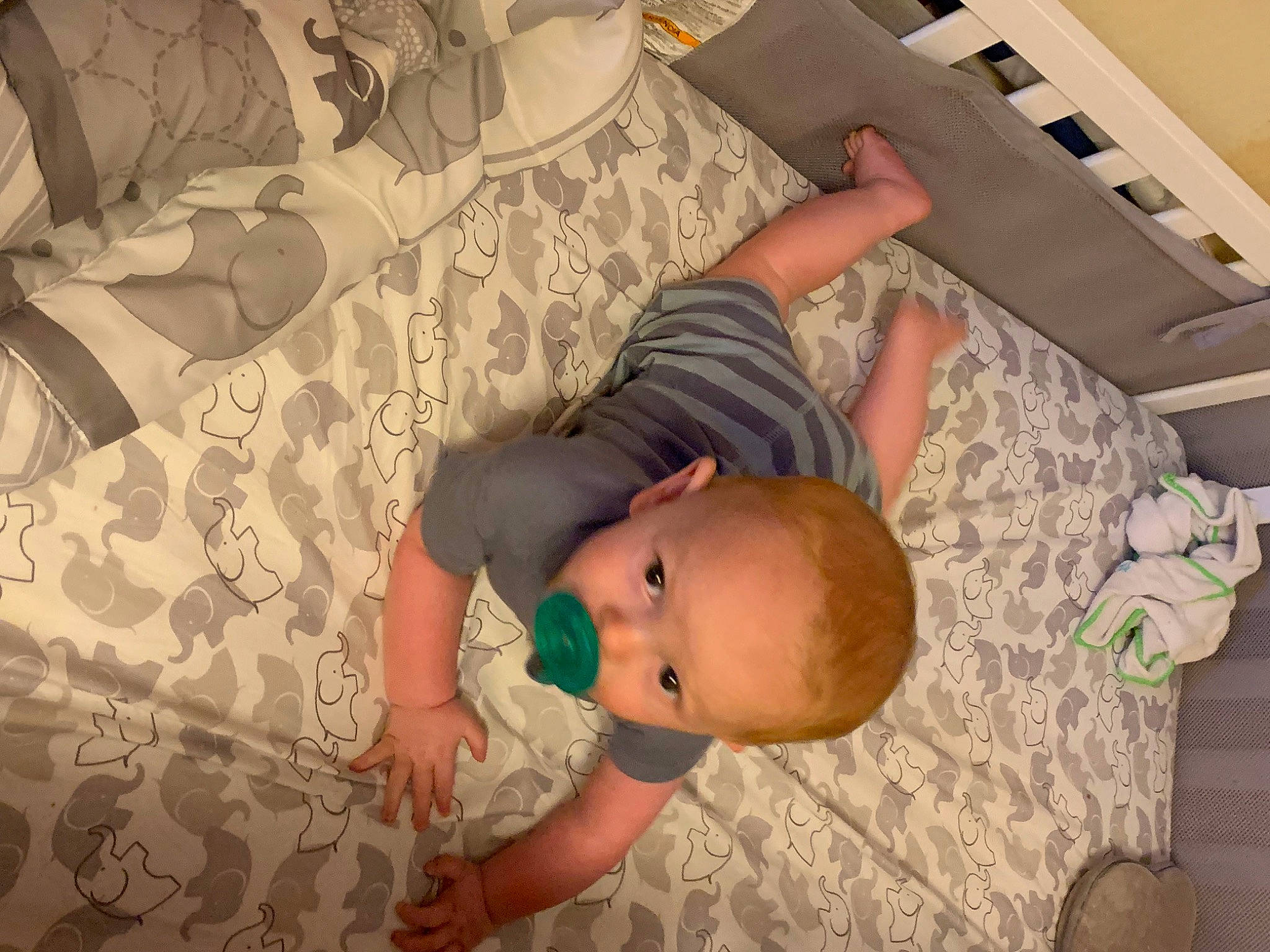 Joshua is registered to the contest to win money with this photo: abdomen, arm, baby, baby_toddler_clothing, chest, child, comfort, elbow, finger, flooring, hardwood, human_leg, linens, pattern, person, room, textile, thigh, toddler, trunk