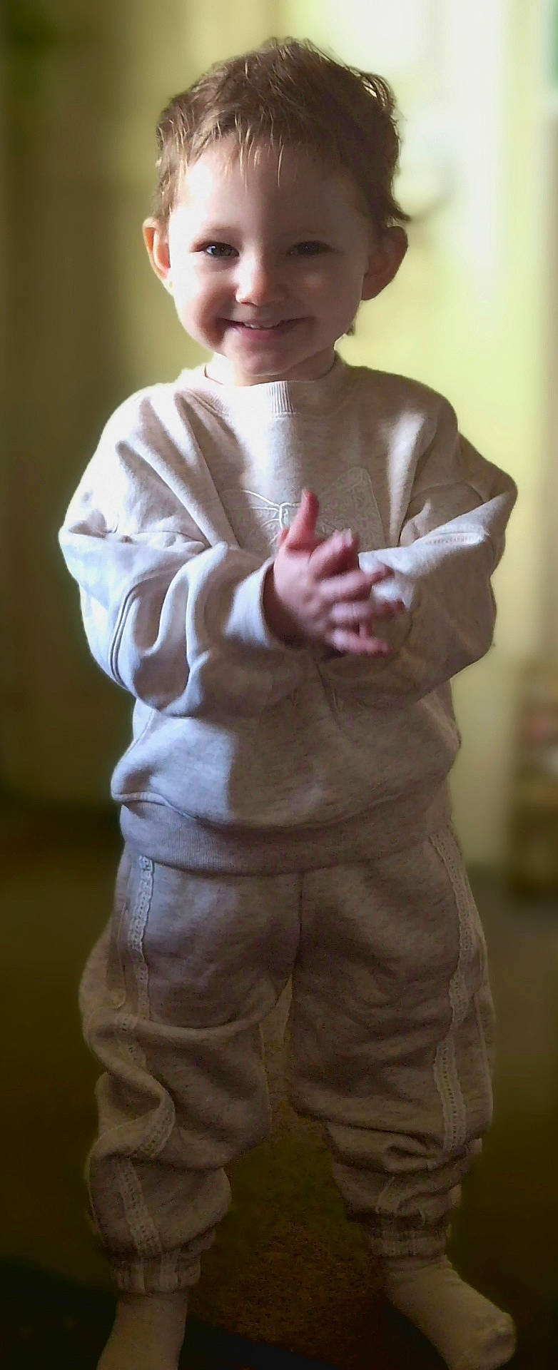 Skylar-Rose joined the competition — help win amazing prizes! apparel, casual, child, clothing, cozy, cute, expression, face, hands, happy, indoors, person, portrait, smiling, standing, sweatpants, sweatshirt, toddler, warm, young