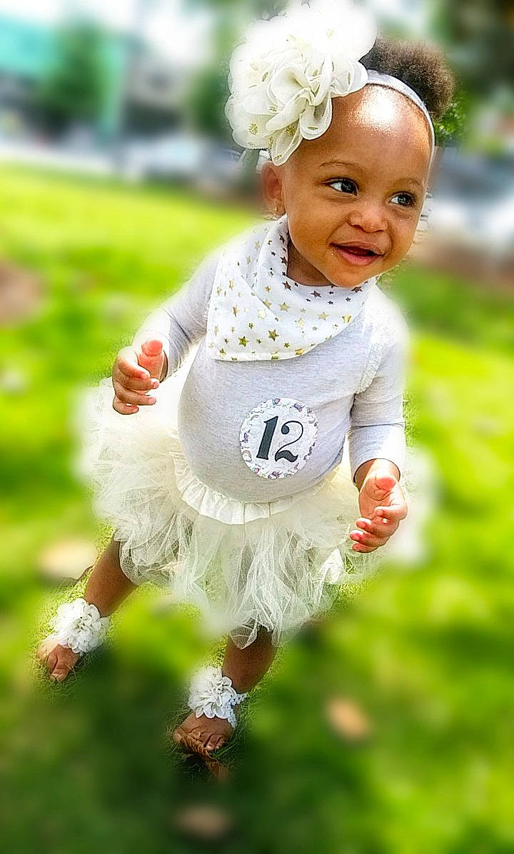 Jazelle is registered to the contest to win money with this photo: baby, baby_toddler_clothing, child, dress, grass, hair_accessory, happy, person, plant, recreation, running, sleeve, smile, toddler