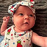 Cali joined the competition — help win amazing prizes! baby, child, headband, hello_kitty, cute, infant, popsicle, patterned_clothing, expression, face, skin, arm, lying_down, blanket, soft_texture, colorful, apparel, closeup, indoors, portrait
