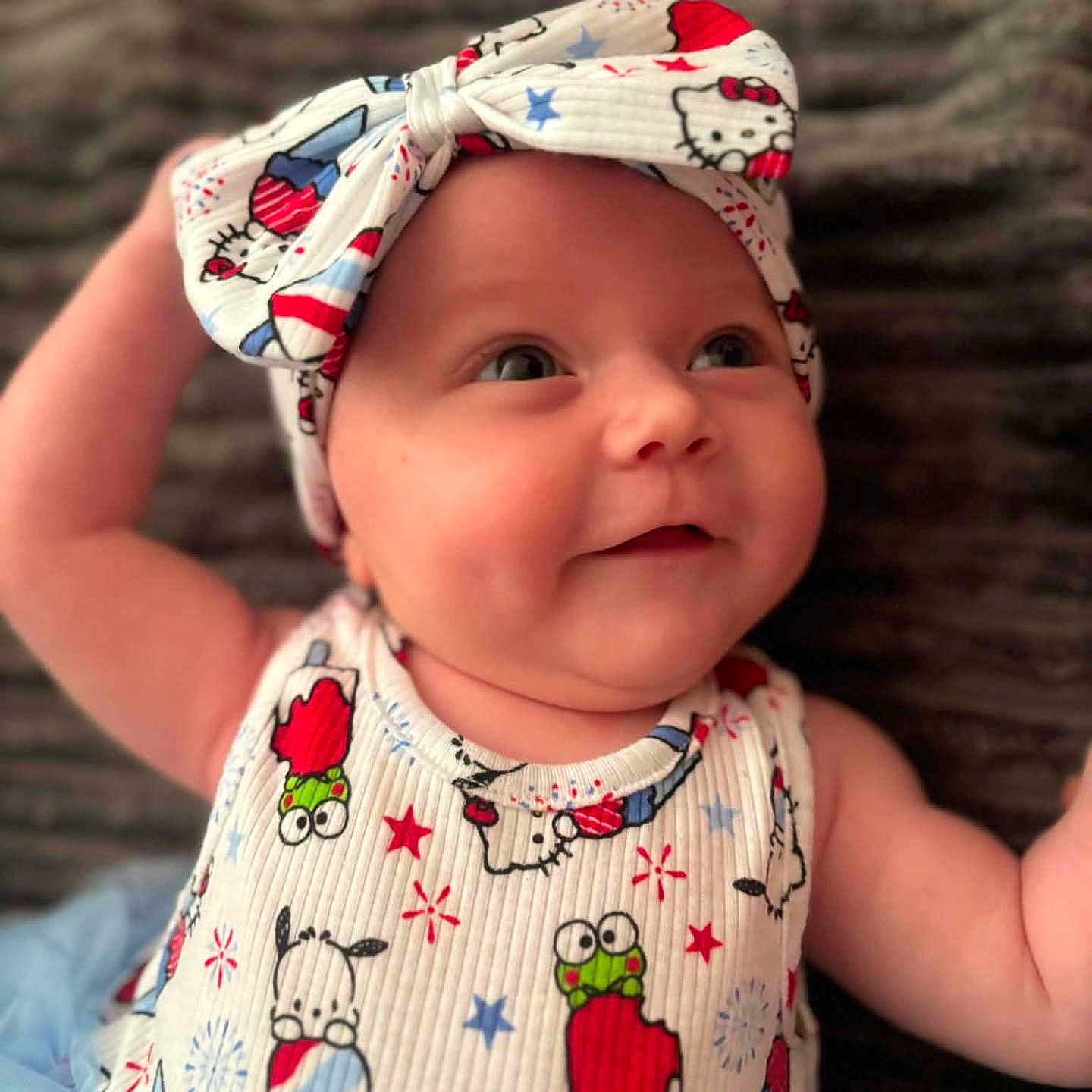 Cali joined the competition — help win amazing prizes! baby, infant, child, smiling, headband, bow, cute, happy, portrait, closeup, clothing, pattern, popsicle, lying_down, soft_background, colorful, fun, young, person, face