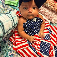 Ava joined the competition — help win amazing prizes! baby, infant, child, portrait, sitting, wide_eyed, bow, navy_bow, dress, american_flag, patriotic, blanket, bed, bedding, cozy, baby_wipes, indoors, textile, adorable, photography