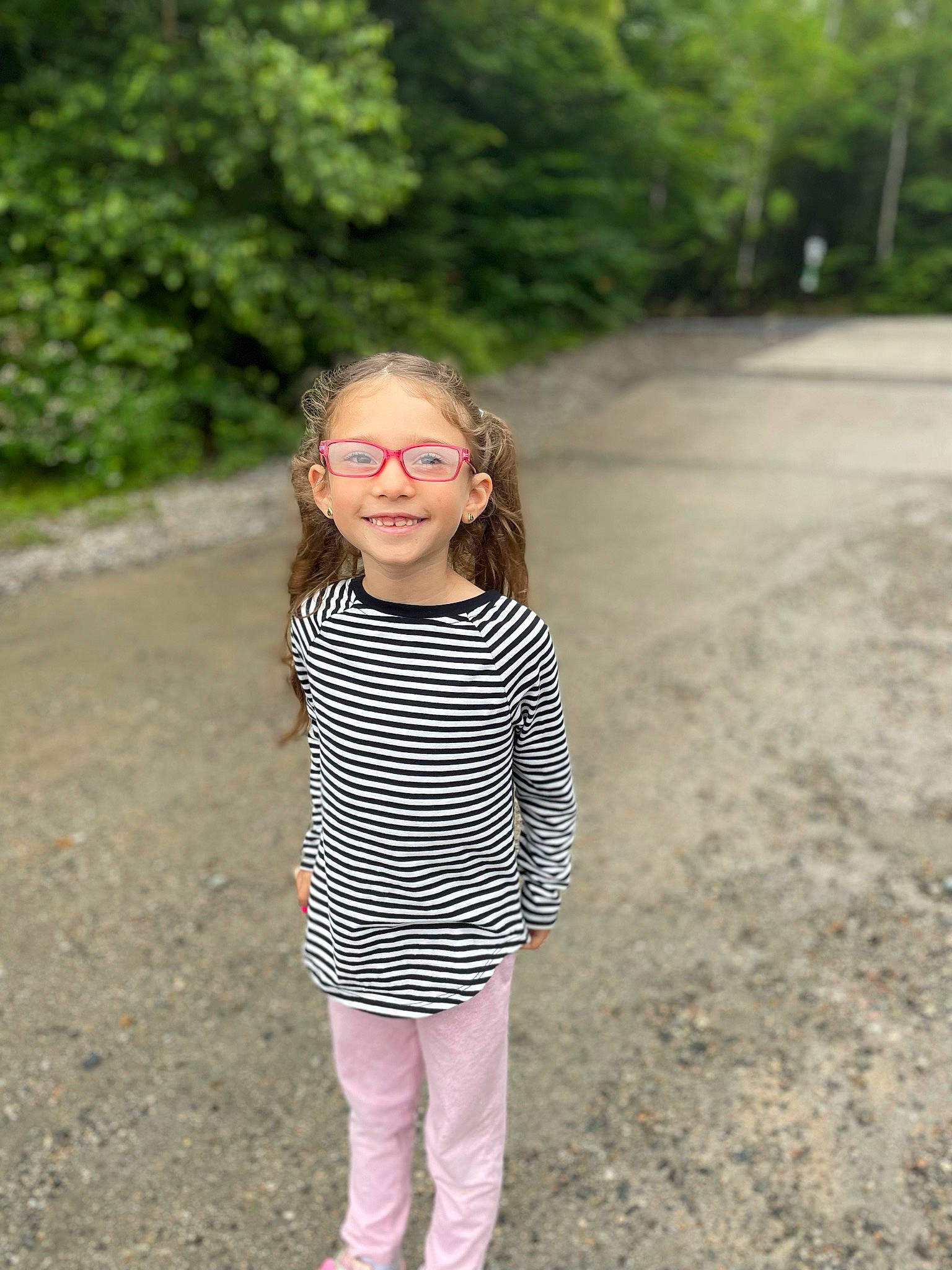 Zoey is registered to the contest to win money with this photo: asphalt, blond, eyewear, face, forest, fun, grass, happy, joy, landscape, leisure, pattern, people_in_nature, person, plant, recreation, road_surface, sleeve, smile, soil