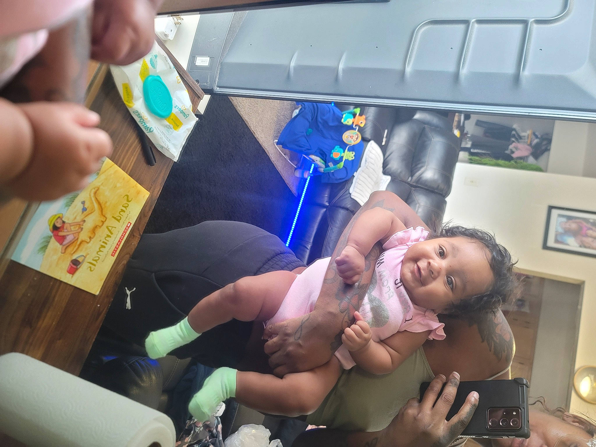 Selassie is registered to the contest to win money with this photo: abdomen, baby, chest, child, event, finger, fun, hand, health_care, human_leg, knee, leisure, medical_procedure, nail, person, picture_frame, shorts, smile, snapshot, thigh