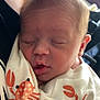 Zailee is registered to the contest to win money with this photo: newborn, baby, sleeping, blanket, crab_pattern, closeup, face, infant, child, person, resting, soft_light, cozy, tender, love, parent, cuddling, cute, peaceful, indoors