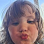 Rosie is registered to the contest to win money with this photo: child, face, selfie, pucker, hair, window, blue_sky, indoor, casual, portrait, young, cute, expression, person, closeup, natural_light, skin, eyelashes, mouth, nostrils