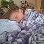 child, sleeping, blanket, pillow, bedroom, indoor, cozy, soft, person, young, resting, home, decor, toy, plant, hair, face, comfort, nap, peaceful