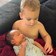 Mateo joined the competition — help win amazing prizes! toddler, newborn, baby, child, blanket, couch, indoor, floor, exercise_ball, shirtless, holding, sleeping, family, infant, home, comfort, love, care, together, relaxing