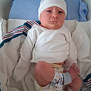Ashen is registered to the contest to win money with this photo: baby, bassinet, bedding, blanket, child, crib, eyes, face, hat, hospital, hospital_bracelet, indoors, infant, lying_down, medical_wristband, newborn, newborn_photography, photograph, portrait, white_clothing