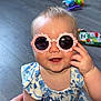 Sierra joined the competition — help win amazing prizes! baby, child, sunglasses, pink, heart_pattern, blue_outfit, floral, smiling, happy, indoor, wooden_floor, toy, hand, crawling, cute, person, infant, fashion, playful, accessory