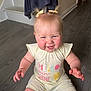 Sierra is registered to the contest to win money with this photo: baby, child, smiling, sitting, floor, wooden_floor, hair_bows, yellow_outfit, cute, indoors, staircase, happy, person, toddler, infant, clothing, face, skin, expression, home