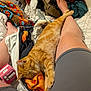 cat, sleeping, ginger_cat, legs, person, blanket, clothing, bed, candy, orange, relaxing, indoor, cozy, comfort, resting, casual, fabric, foot, nap, home