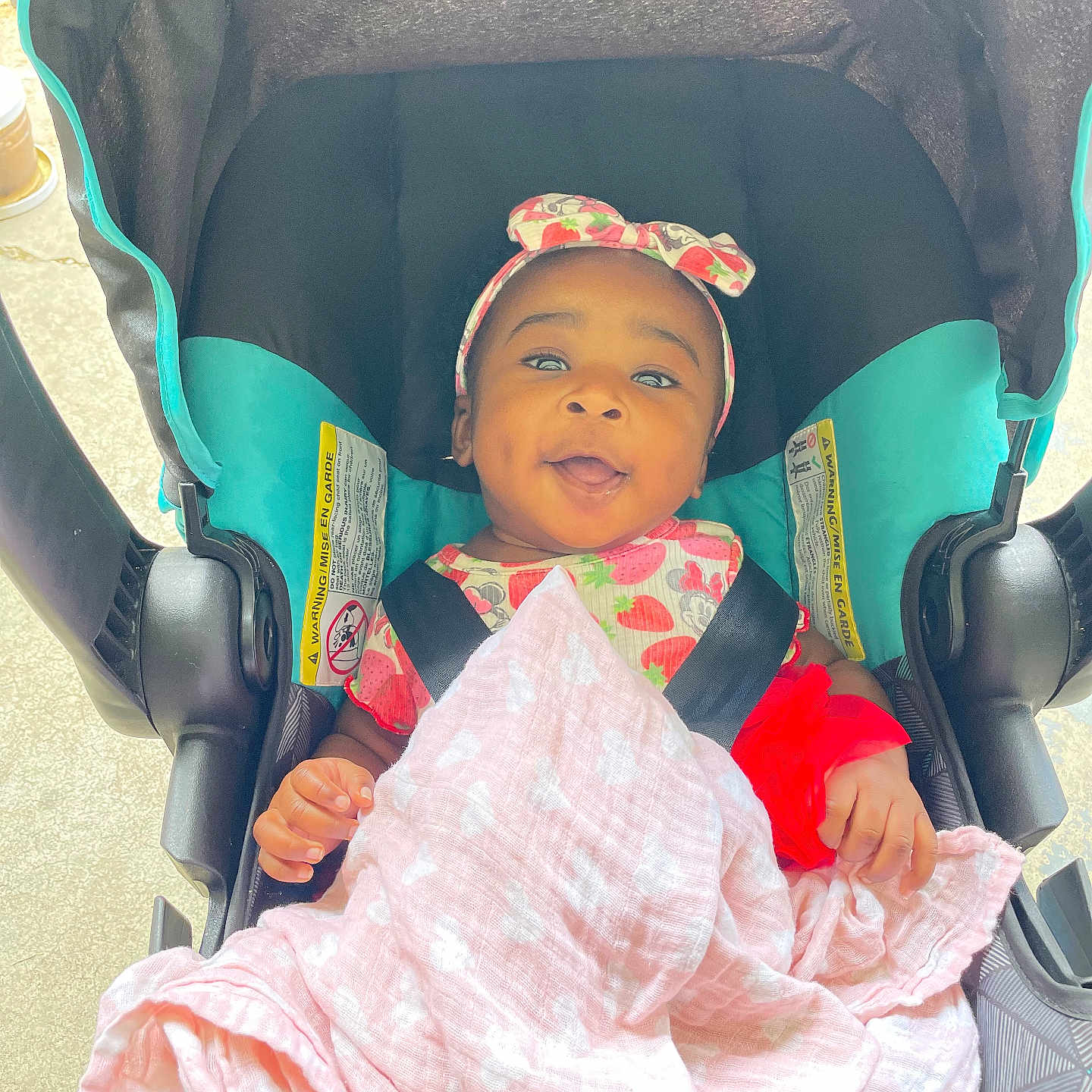 Zahrah joined the competition — help win amazing prizes! baby, baby_girl, blanket, car_seat, child, clothing, cute, face, happy, headband, indoors, infant, pattern, person, pink, portrait, red, seat_belt, smiling, toddler