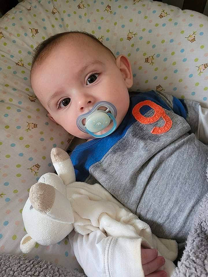 Mason a rejoint le concours — aidez-le/la à gagner de superbes lots ! baby, baby_products, baby_safety, baby_sleeping, baby_toddler_clothing, cheek, child, comfort, eye, face, headgear, iris, linens, person, room, sitting, skin, sleeve, toddler, white