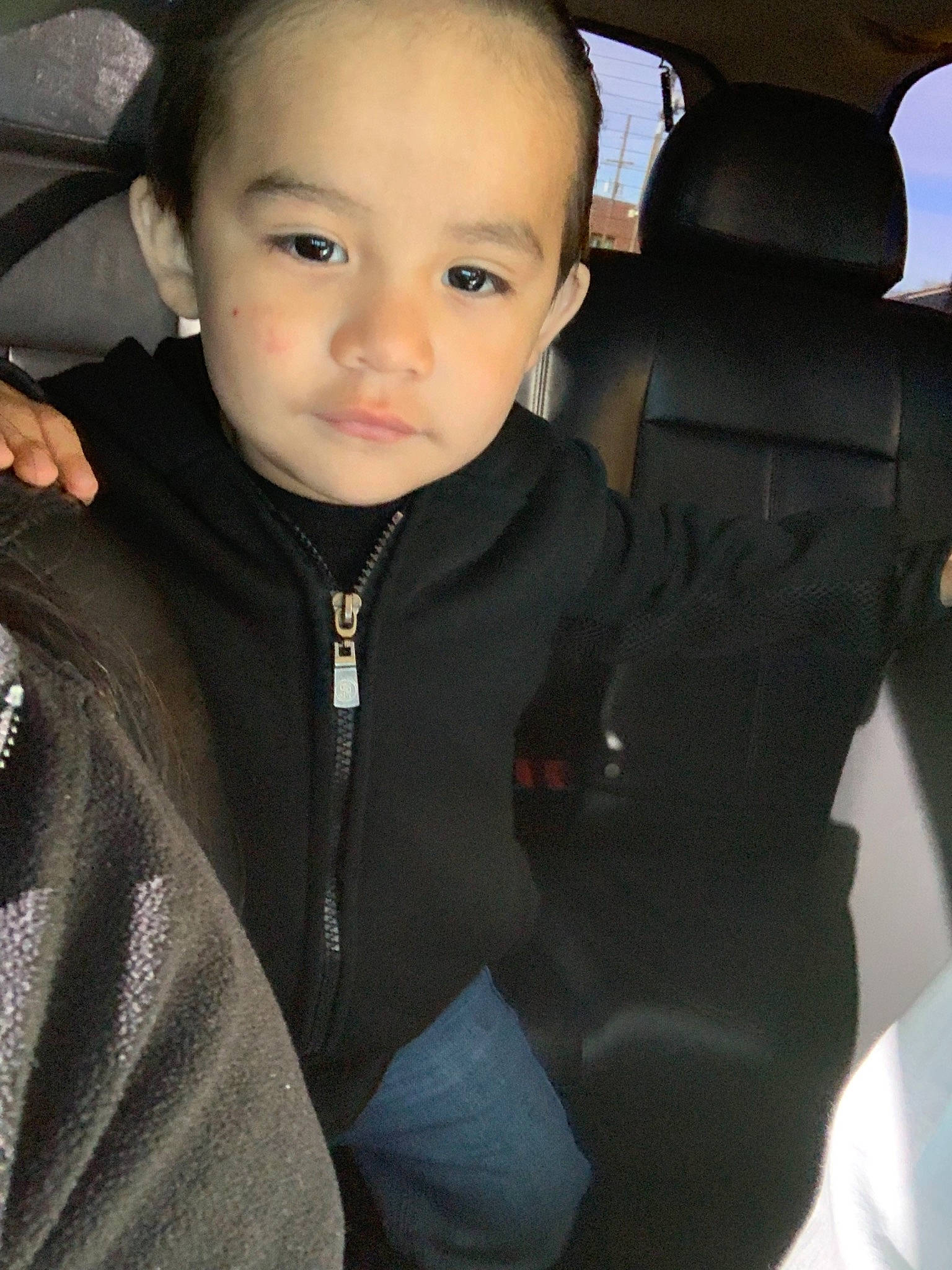 Julian is registered to the contest to win money with this photo: car_seat, cheek, child, face, person, smile, toddler