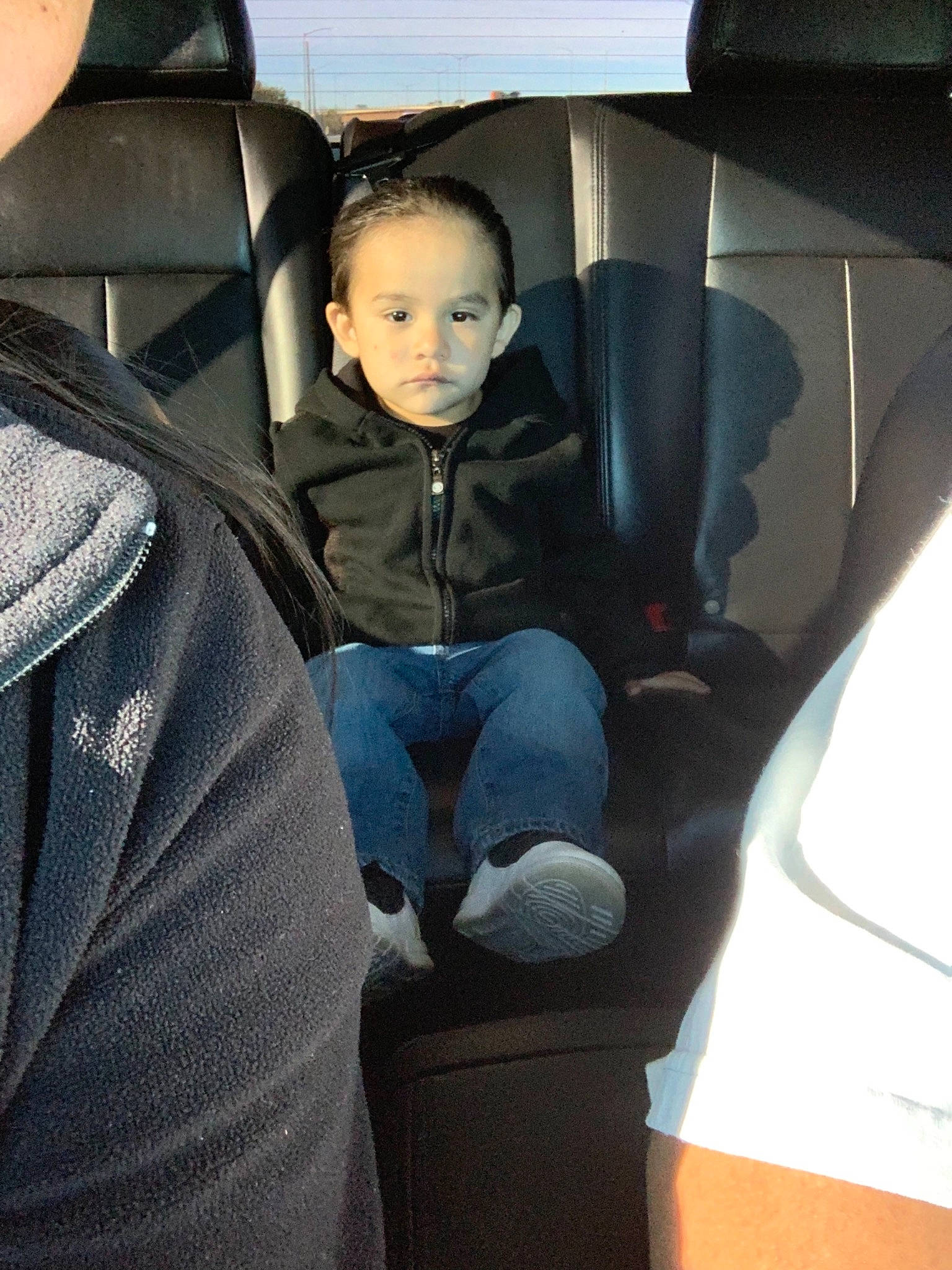Julian is registered to the contest to win money with this photo: auto_part, car, car_seat, car_seat_cover, child, family_car, head_restraint, luxury_vehicle, person, seat_belt, sitting, toddler, vehicle_door