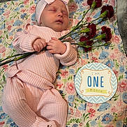 Delaney joined the competition — help win amazing prizes! baby, infant, sleeping, pink_outfit, headband, bow, flowers, carnations, floral_blanket, milestone, one_month, portrait, newborn, lying_down, indoors, hands, cozy, celebration, nursery, photography