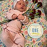 baby, infant, sleeping, pink_outfit, headband, bow, flowers, carnations, floral_blanket, milestone, one_month, portrait, newborn, lying_down, indoors, hands, cozy, celebration, nursery, photography