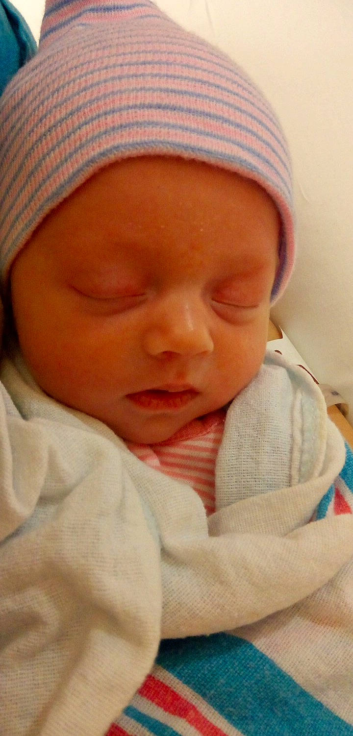 Jaklynn is registered to the contest to win money with this photo: baby, baby_sleeping, cap, cheek, chin, comfort, eyebrow, face, finger, forehead, hand, head, headgear, headwear, lip, mouth, nose, person, skin, smile