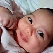 Kenza a rejoint le concours — aidez-le/la à gagner de superbes lots ! baby, smiling, close_up, face, infant, blanket, cozy, cute, eyes, expression, soft, skin, newborn, happy, portrait, child, indoors, person, sleepwear, young