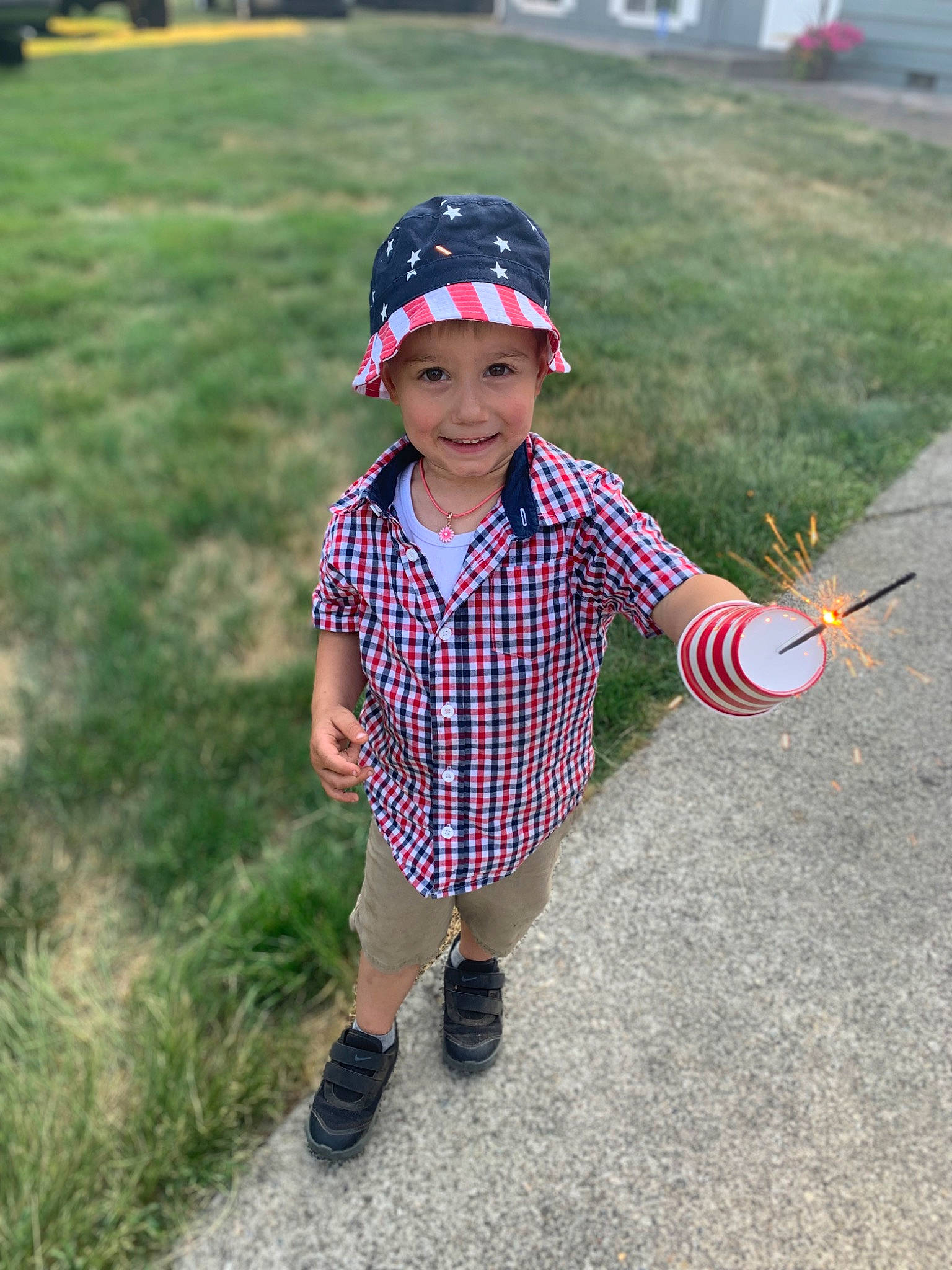 Jaxson is registered to the contest to win money with this photo: asphalt, baseball_cap, cap, electric_blue, eyewear, fun, grass, happy, hat, headwear, joy, leisure, pattern, person, plaid, plant, recreation, sleeve, smile, t_shirt