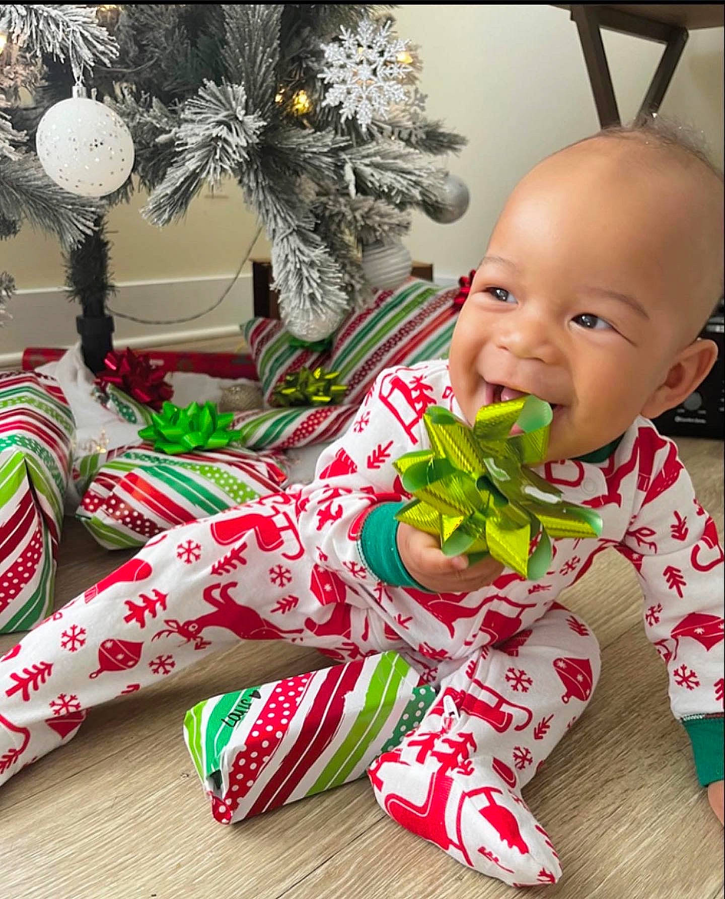 Lennox is registered to the contest to win money with this photo: baby, baby_toddler_clothing, child, christmas, christmas_decoration, christmas_ornament, design, event, green, happy, holiday, holiday_ornament, mammal, ornament, pattern, person, sleeve, smile, textile, toddler
