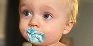 Declan is registered to the contest to win money with this photo: toddler, child, blue_eyes, frosting, messy_face, indoor, portrait, shirtless, blond_hair, closeup, baby, face, expression, cute, young_child, skin, person, food, snack, innocent