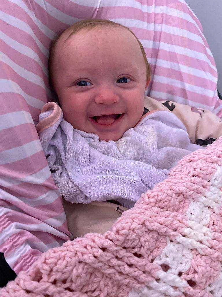 Ariana is registered to the contest to win money with this photo: art, baby, baby_products, baby_toddler_clothing, cheek, child, comfort, face, happy, joy, linens, magenta, pattern, person, pink, purple, skin, sleeve, smile, textile